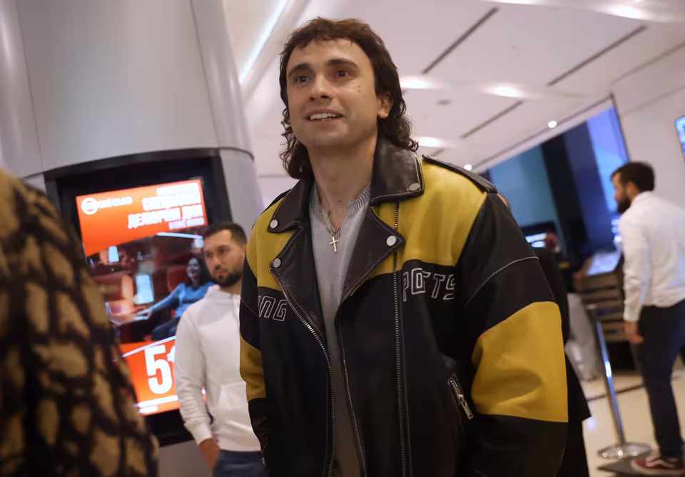 Guest in a yellow and black racing jacket in the foyer