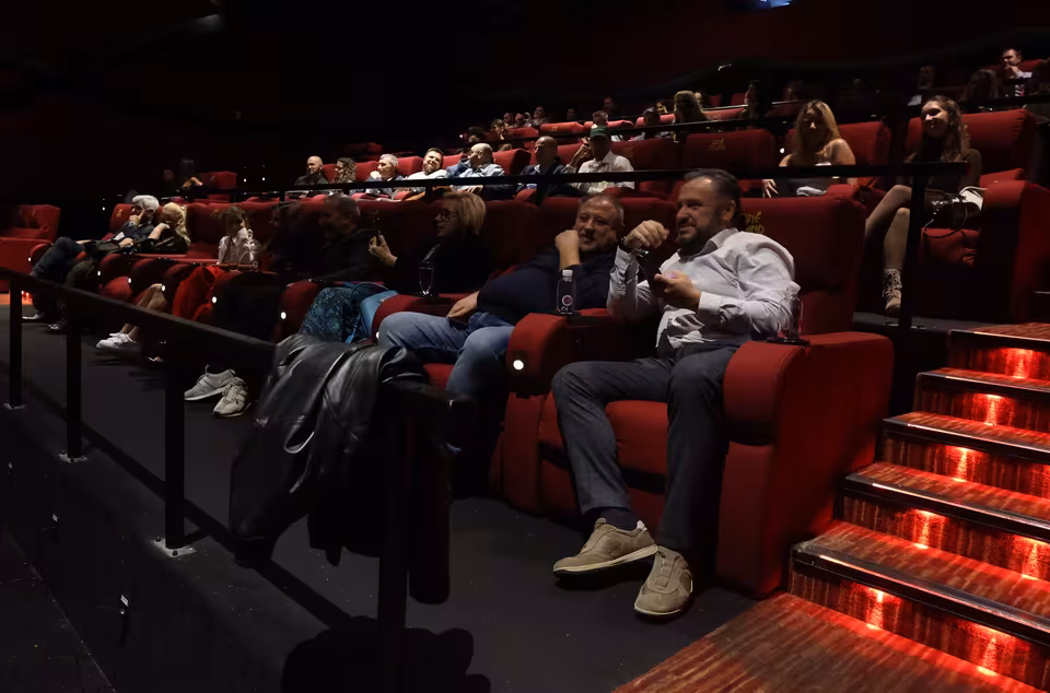 Guests taking their seats in the cinema hall
