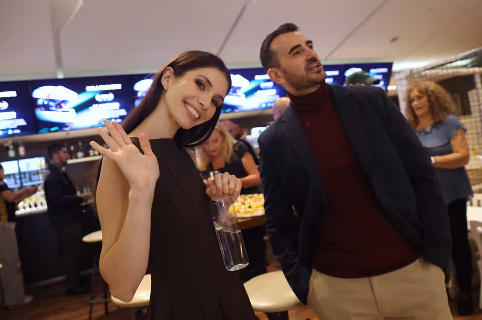 Guests waving at the camera in the foyer