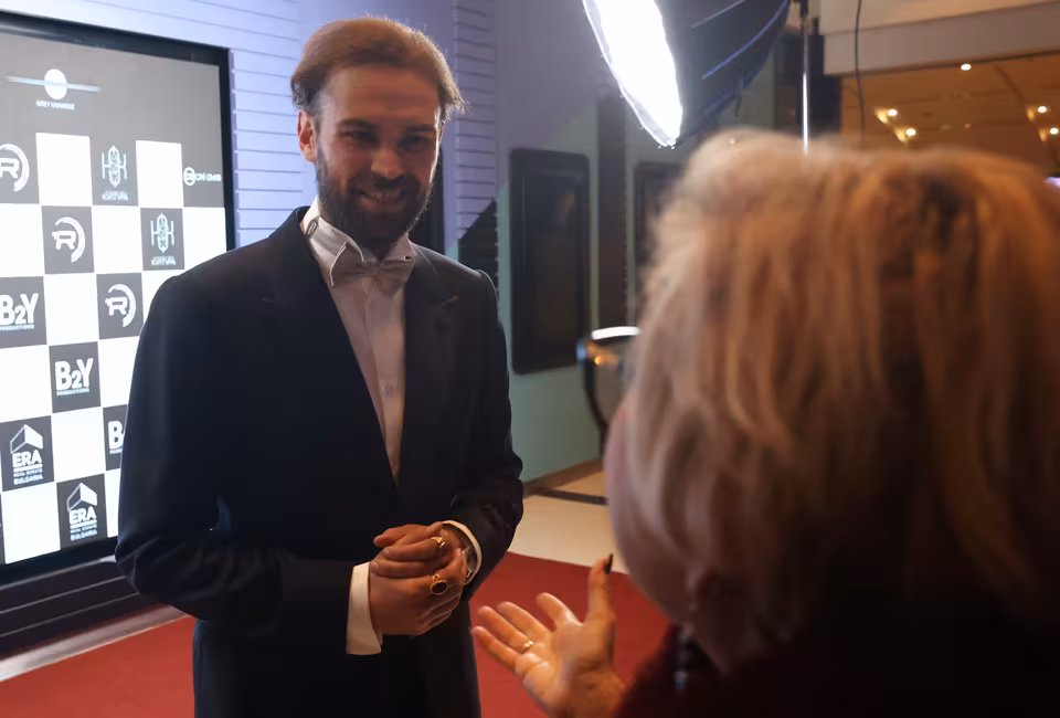 Guest in a tuxedo being interviewed