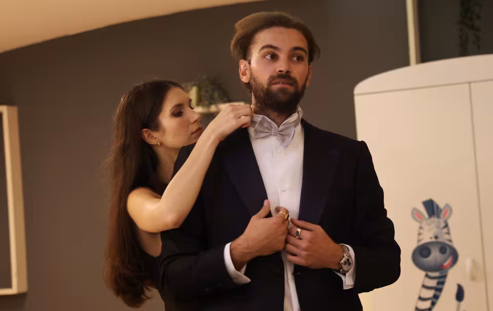 Fixing a bow tie before the premiere